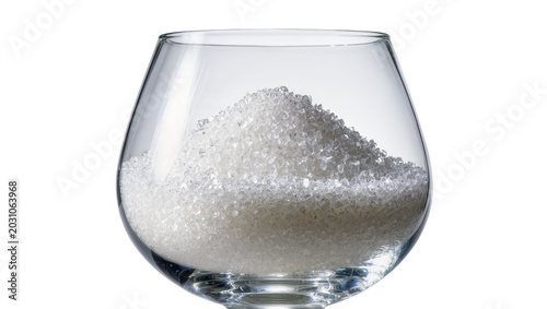 Tableau sur toile Clear glass brandy snifter filled with sparkling white sugar, isolated on transp