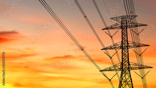 Fotografie An electric tower silhouetted against a vibrant orange and yellow sunset sky