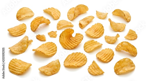 Scattered ridged potato chips on a white background