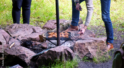 Photos Juicy pork shashlik chunks on metal skewers grill over an open barbecue with glowing charcoal embers