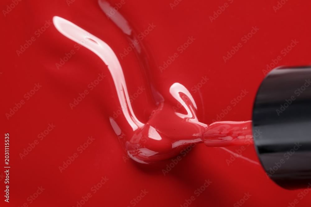 Naklejka premium Red nail polish and brush as background, above view. Space for text