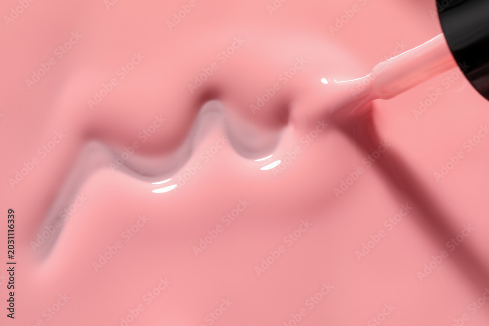 Obraz premium Pink nail polish and brush as background, above view. Space for text