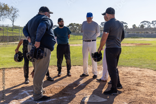 Billede på lærred Group of six men, one senior, standing at home plate wearing baseball caps holdi