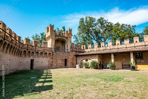 Photos Gradara castle courtyard showcases ancient brick walls and crenellated battlemen