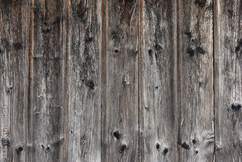 Weathered wooden plank wall background with rustic texture and aged wood grai...