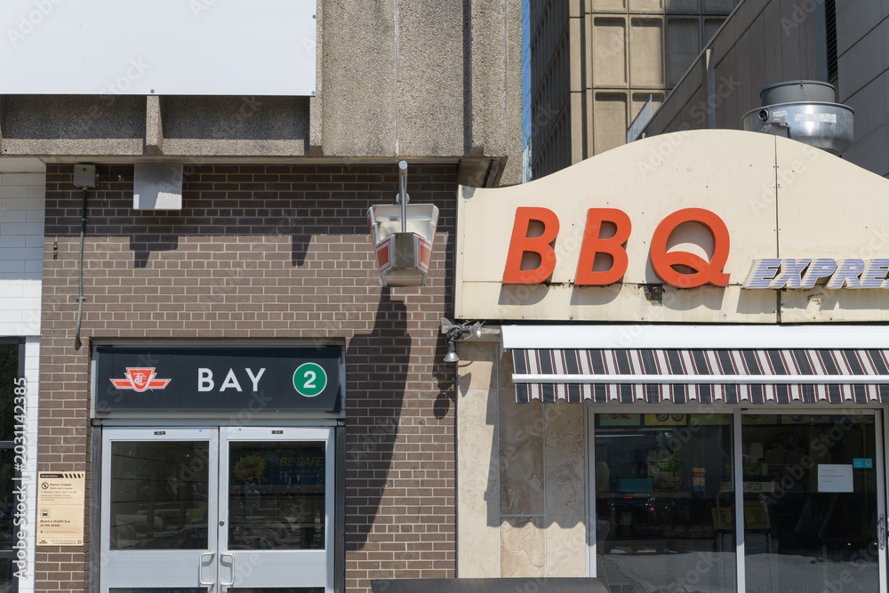 Fototapeta premium secondary Line 2, Bay station entrance and BBQ Express signage at 18 Bellair St #12, near Cumberland St, Yorkville, Toronto