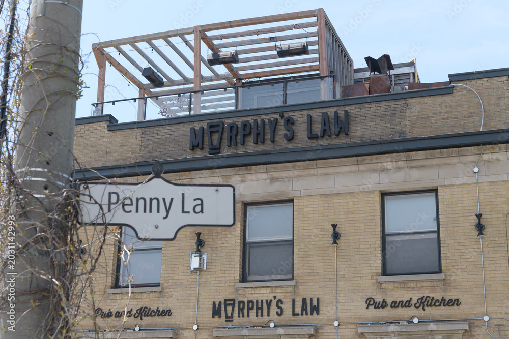 Naklejka premium ghost signs outside Murphy's Law Pub and Kitchen at 1702 Queen St E and Penny Ln, Toronto