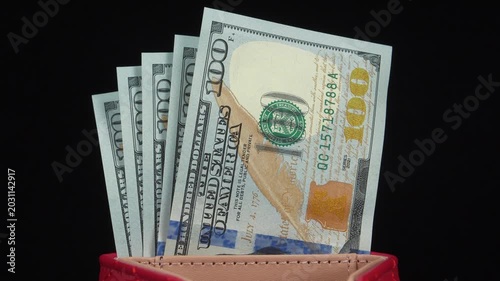 American dollars in wallet. Five new blue 100 dollar bills. 500 dollars banknotes in wallet. Cash, finance, savings, wealth. New hundred dollar bills in red leather wallet