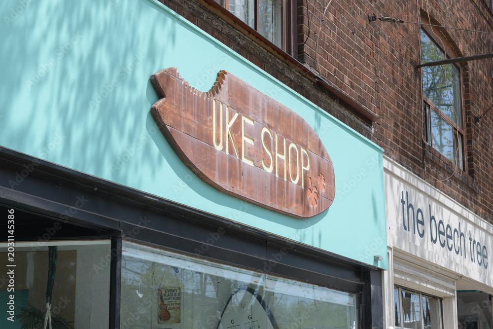 Naklejka premium signs for Ukes Abroad, a music school, and The Beech Tree, a restaurant, located at 922-924 Kingston Rd, Toronto