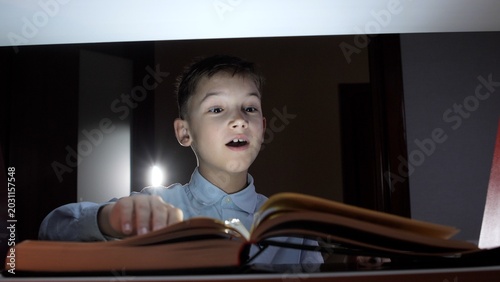 Fotografie Young boy with wide eyes and an open mouth reacting in awe and surprise to an op