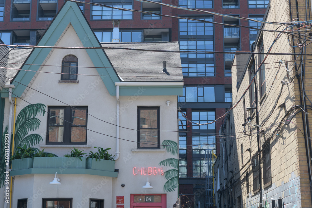 Naklejka premium exterior building and neon sign of Chubby's Jamaican Kitchen located at 104 Portland St, Toronto