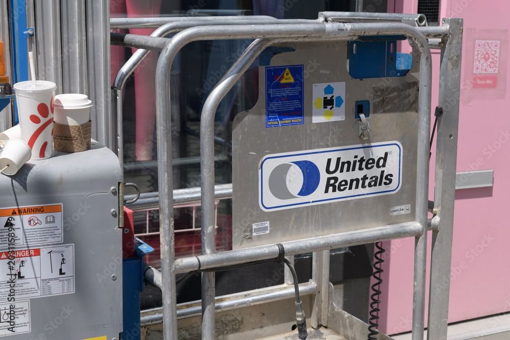 Naklejka premium aerial work platform (also called lift platforms or mobile elevated work platforms/MEWPs) with United Rentals sticker and other objects on Queen St W, Toronto
