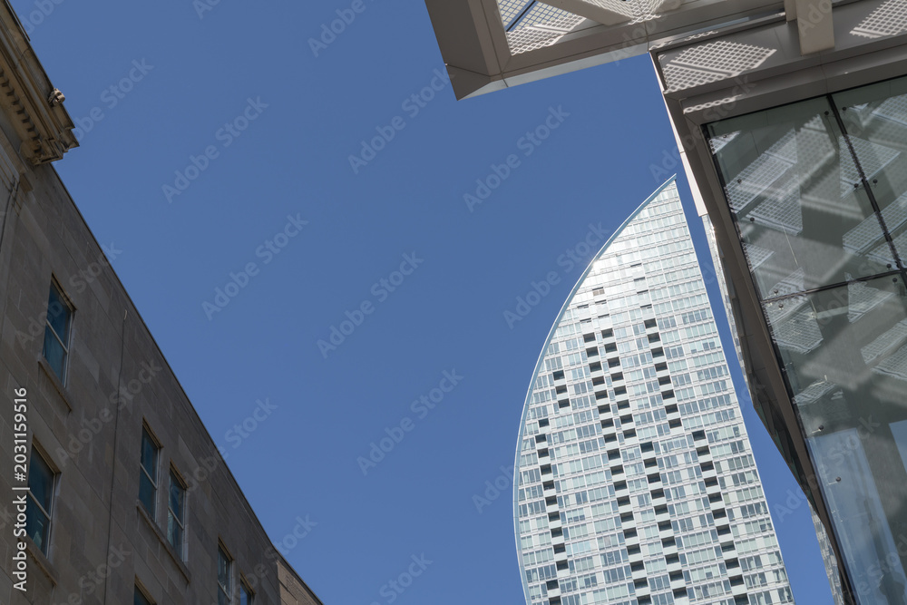 Naklejka premium dramatic, sculptural sweep of L-Tower's curved top profile designed by Daniel Libeskind at 8 The Esplanade, Toronto