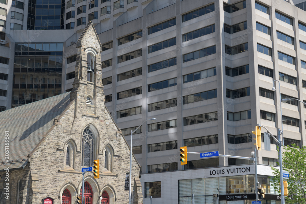 Naklejka premium wide view of northeast corner of Avenue Rd and Bloor St W, incl Louis Vuitton, a leather goods store, located at 150 Bloor St W, Toronto