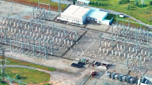 High voltage power substation with complex electrical grid and extensive transmission lines observed from an aerial perspective