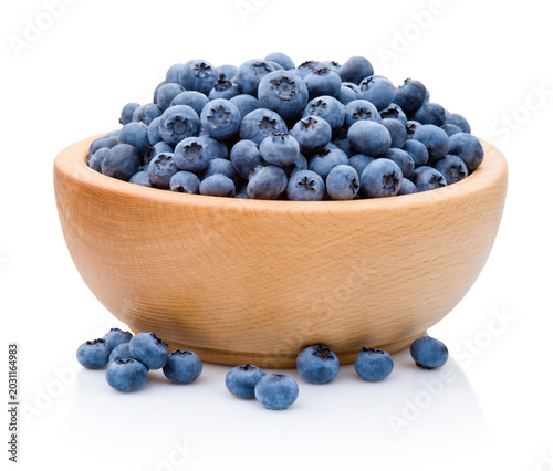 Fresh blueberries on wooden bowl isolated on white background