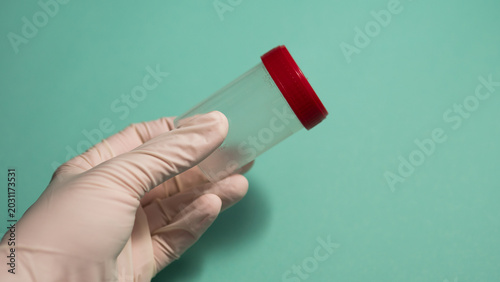 Quadro su tela Gloved Hand Holding Empty Specimen Container with Red Cap — Medical Sample Colle