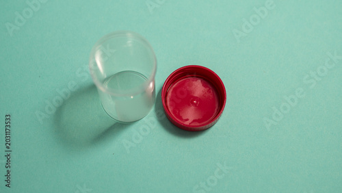 Bild auf Leinwand Open Specimen Container Upside Down with Red Cap — Medical Sample Collection Det