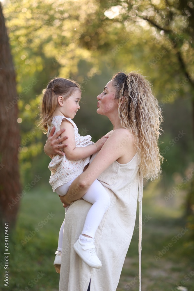 Fototapeta premium Mother with her cute little daughter in nature