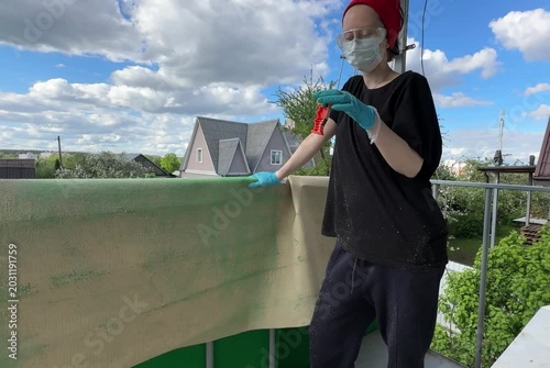 Person cleaning a carpet on a balcony with a brush that breaks, illustrating outdoor cleaning challenges, unexpected problems, or the need for durable tools
