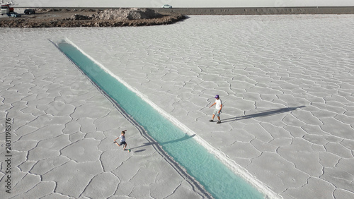 Konstfotografi Aerial view of father and child playing football onwhite salt flats Salinas Juju