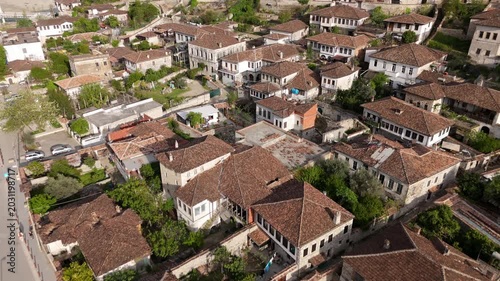 Drone Flying Backward Over Historic Red Tile Roofs with Christian Quarter Reveal in Berat