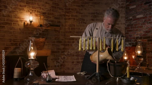 vintage candle maker pouring water in a bucket