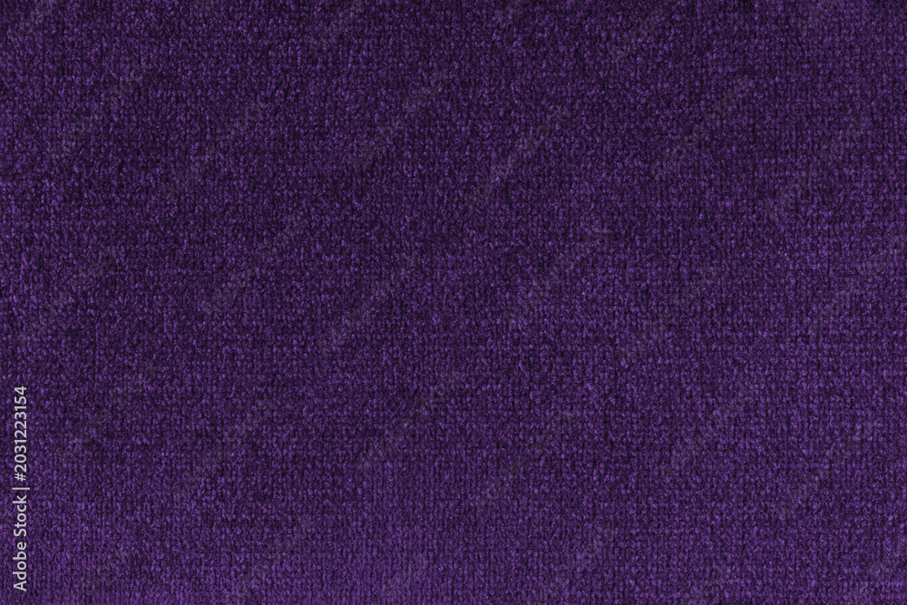 Fototapeta premium Close up, macro of purple fabric texture with soft velvet, fluffy woven surface, rich textile detail. Knitted jersey cloth background, backdrop, wallpaper for design, fashion or interior projects