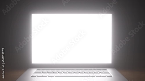 Open laptop with glowing white screen and silver keyboard on gradient background in close-up shot