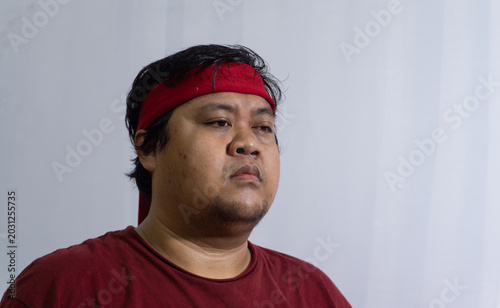 Принти на полотні Sad Indonesian male sports fan looking away with a defeated and emotional expres