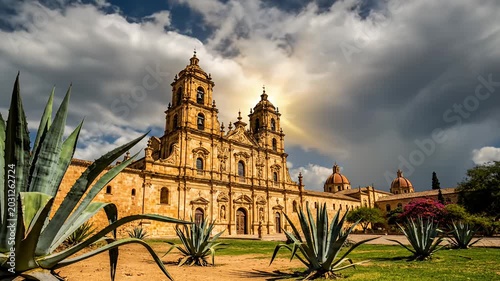 Historical building with cloudy sky and green plants in a daytime setting