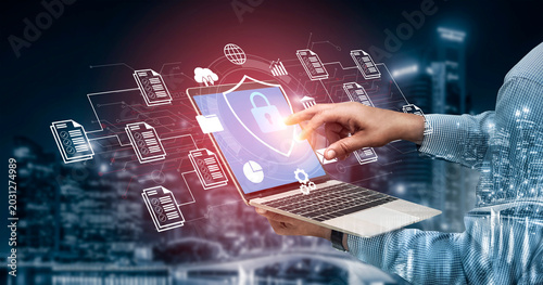 Foto A person interacts with a laptop featuring digital security graphics, surrounded by data imagery in a vibrant urban night scene, emphasizing modern technology and cybersecurity