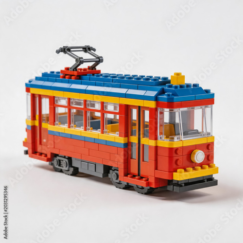 A detailed LEGO brick built vintage electric tram model, featuring red, blue and yellow color scheme, clear window panels and functional pantograph on the roof.