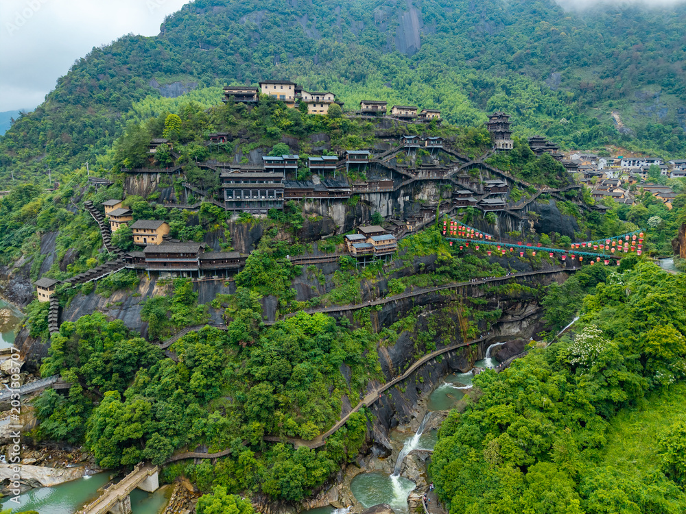 Obraz premium Aerial view showing the scenic buildings and lush green mountains of Wangxian Valley in Jiangxi China Traditional wooden houses