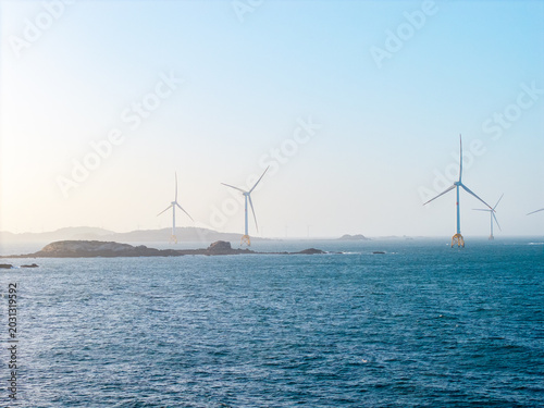 Large wind turbines stand in the ocean near the coast of Pingtan in Fujian China