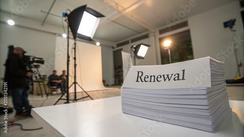 Stack of Papers with Renewal Word on Table in Studio Setting