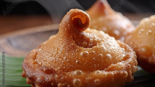 Closeup of a delicious fried pastry with a unique swirl on top.