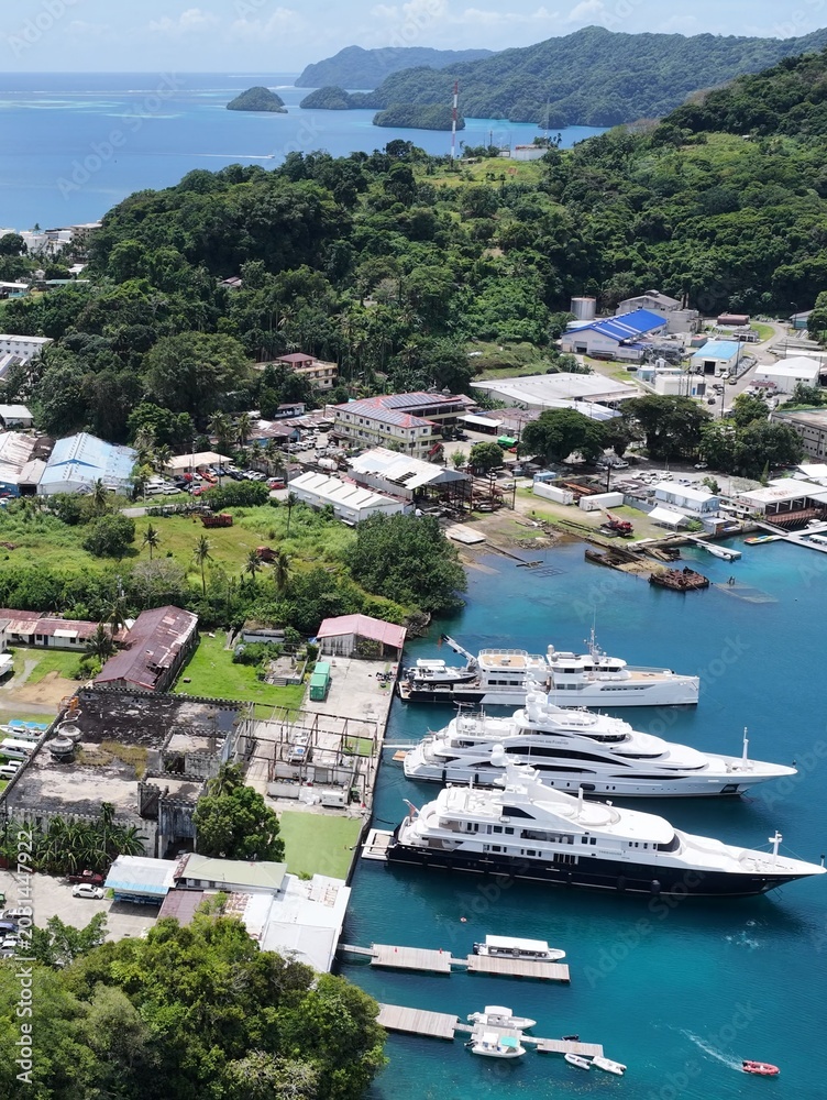 Obraz premium Aerial View of Luxury Superyachts Docked in Koror Harbor Palau