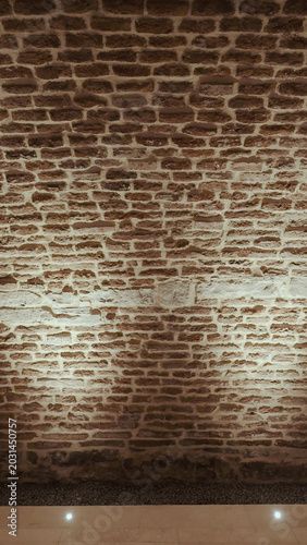 Fotografija Illuminated brick wall texture exhibition space with dramatic rustic atmosphere
