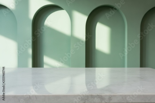 White marble countertop surface with sage green arched wall background, and sunlight shadows