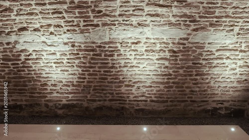 Illuminated brick wall texture exhibition space with dramatic rustic atmosphere loop video