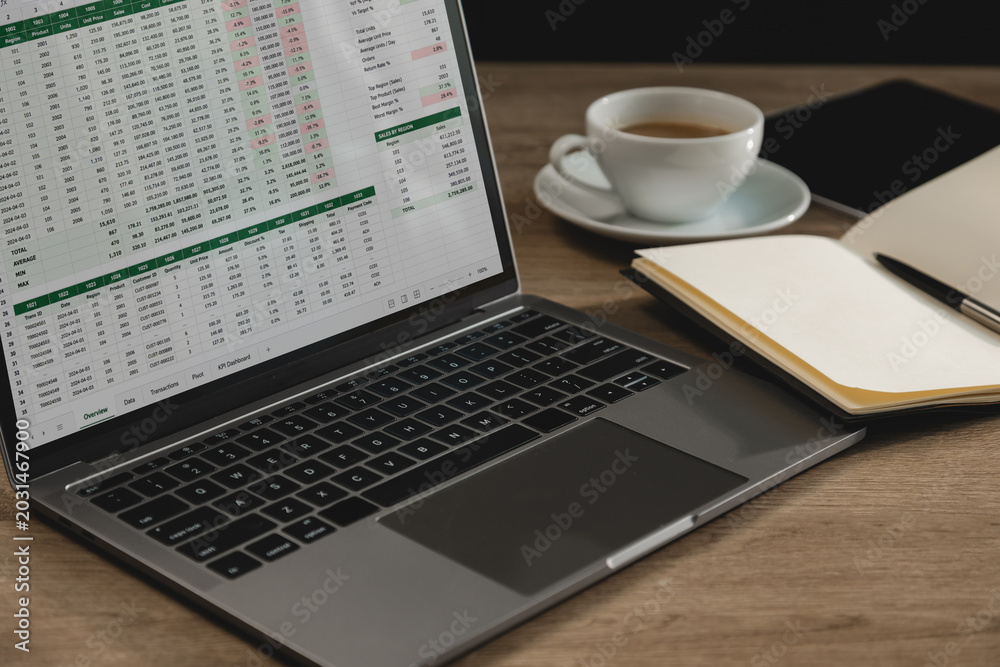 Fototapeta premium Laptop displaying spreadsheet documents with financial tables and online business reports on workspace desk, supporting data analysis, accounting workflow, project monitoring, and digital reporting.