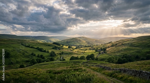 Dramatic Sun Rays Breaking Through Clouds Over Lush Green Valley