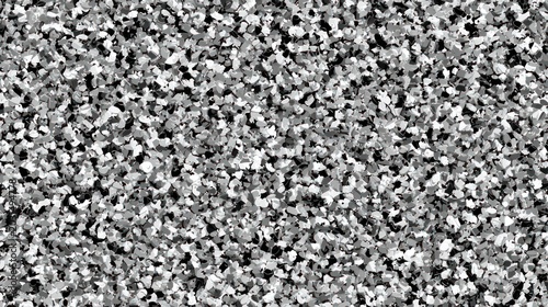 Textured surface composed of dense, irregularly shaped chips in shades of black, white, and gray.