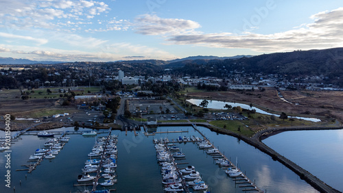 Принти на полотні Waterfront Park marina featuring numerous docked boats, a tranquil pond, and dis