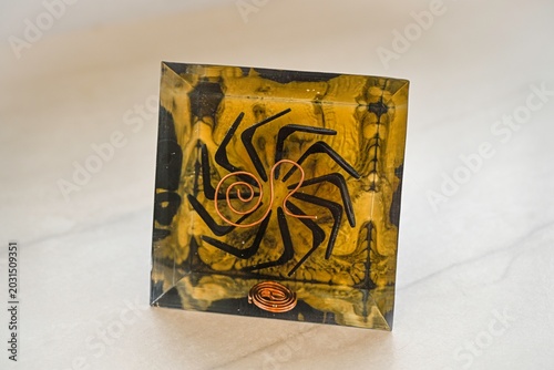 Handmade Orgone Pyramid with Pyrite Crystal and Obsidian Layers – Unique Black and Gold Energy Pyramid with Circular Metal Geometry, Close-Up Isolated on White Background
