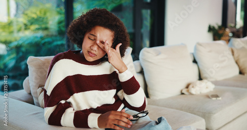 Φωτογραφία Crying, child and sadness on couch, home and girl with low self esteem from bullying or bad memories