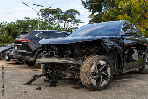 Damaged Black SUV After Car Accident in Outdoor Parking Area