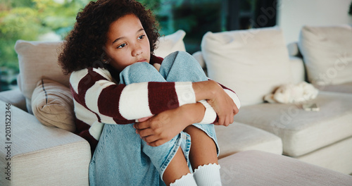 Tableau sur toile Lonely, child and thinking on sofa, home and girl with low self esteem from bullying or bad memories