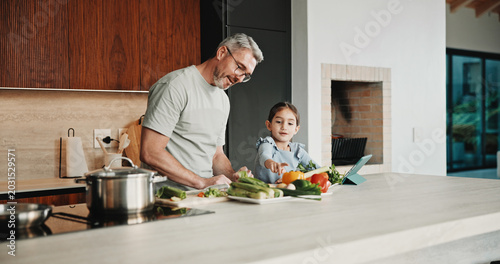 Photos Father, girl and teaching with tablet, cooking and meal prep in home for education